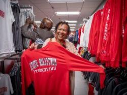 Woman holds up Montclair shirt.