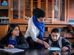 Photo of young teacher with students.