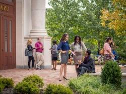 Graduate School students talking outside of University Hall entrance