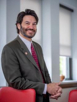 Montclair State University President Jonathan Koppell poses inside a building on campus.