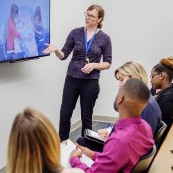 Image of a faculty member in the Psychology Services Clinic showing students a technique for assessment