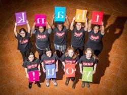 photo from abve of students holding signs with letters spelling out thank you