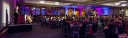 Dinner guests at tables listening to speaker at Annual Scholarship Dinner event.